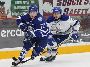 Dawson Baker, right, of the Sudbury Wolves, and Albert Michnac of the Mississauga Steelheads, fight for the puck during OHL action at the Sudbury Community Arena in Sudbury, Ont. on Saturday November 4, 2017. John Lappa/Sudbury Star/Postmedia Network