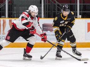 Sarnia Sting's Nick Grima (7) battles Austen Keating (9) of the Ottawa 67's for the puck in the first period at TD Place in Ottawa on Sunday, Nov. 5, 2017. (Postmedia Network)