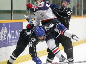 Sudbury Nickel Capital Wolves Hunter Chiblow and Carson McMillan tie up Ryan O'Hara of the Mississaugua Rebels during midget championship game action at the 38th annual Big Nickel Tournament. Gino Donato/The Sudbury Star/Postmedia Network