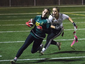 Kona Haas, left, of the Confederation Chargers, attempts to avoid a Marymount Regals player during action at the girls flag football final at James Jerome Sports Complex in Sudbury, Ont. on Friday November 3, 2017. John Lappa/Sudbury Star/Postmedia Network
