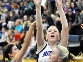 Elaine White of the MDHS senior girls basketball team out jumps her Stratford Central opponents for this rebound and eventual putback basket during action from their Huron-Perth quarter-final playoff game Nov. 1, a 57-16 victory. ANDY BADER/MITCHELL ADVOCATE