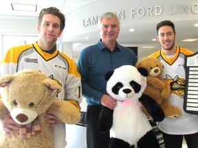 Taking part in Monday's kickoff for the 20th annual Lambton Ford Teddy Bear Toss are, from left, Jordan Ernst with the Sarnia Sting, Lambton Motors president Rob Ravensberg and  Anthony Salinitri, of the Sarnia Sting, who scored last year's Teddy Bear Toss goal. This year's event is set for Dec. 3, when the Sting host the Oshawa Generals in Sarnia. When the home team scores it's first goal of the game, spectators who have brought stuffed animals to the game toss them to the ice. They're collected and donated to social agencies in the community. Over the last two decades, the event has collected more than 55,000 stuffed toys.
(Paul Morden/Sarnia Observer)
