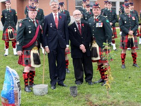 An oak sapling that is a descendant from an oak tree on the battle field of Vimy Ridge, was planted at the Col. E.M. Ansel Armoury in Chatham on Saturday, Nov. 4. From left are Regimental Sgt. Major Brian Jordan, Henry Taekema and Jerry Hind, local residents who arranged to get the oak sapling, and Lt. Col. John Hodgins, Commanding Officer.