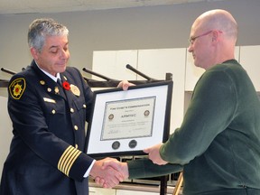 West Perth Fire Chief Bill Hunter (left) presented the first-ever Fire Chief Commendation award in the Organization category - as well as the award’s signature piece, a coin - to Dwight Rerup, Armtec plant manager, during a brief ceremony at their Mitchell plant Monday, Nov. 6. ANDY BADER/MITCHELL ADVOCATE