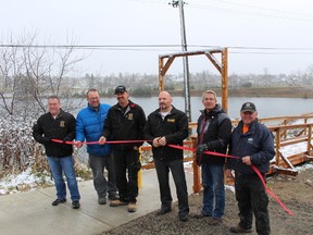 Director of Protective Services Richard Vallee, Director of Infrastructure Services Shane Skinner, Roger Robin, Mayor Peter Politis, Councillor Darryl Owens and Marc Grenon were at the ribbon cutting ceremony for the new boardwalk that was constructed at the hill between Seventh Avenue and the Band Stand.