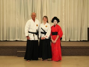 Staines poses with her Sensei of six years, Ron Tyndall, along with the ceremony assistant who donned traditional geisha attire. (SHEILA PRITCHARD/CLINTON NEWS RECORD)