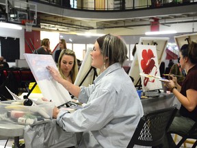 Local artists take part in a painting competition during Art Canvas Action at the Allan and Jean Millar Centre on Nov. 4. From the left, Justine Vandenhouten, Karen Rhebergen and Candace Laprise compete in the OG canvas category. See story on page 5 (Peter Shokeir | Whitecourt Star).