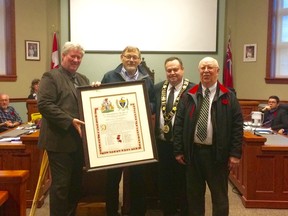 (L-R): Patrick Nagle, Sid Bruinsma, Mayor Kevin Morrison, and Jim Rutledge with the scroll of remembrance. The scroll lists the names of the “Huron County 20” who laid down their lives for the liberation campaign in the Netherlands in 1944 and 1945. (Kathleen Smith/Goderich Signal Star)