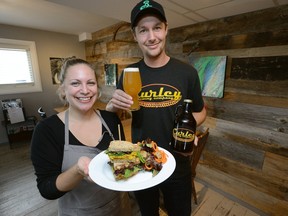 Nigel Curley and Kelsey Watkinson show off their Hoprunner IPA beer and a curried chickpea sandwich with salad at the Curley Brewing Co. (MORRIS LAMONT, The London Free Press)