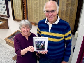Retired teachers Connie Weir and Pete Telford stand next to the names of London South Collegiate Institute students that served in the Second World War. Along with teacher Jerry Selk and generations of South students, they’ve produced a book chronicling the lives of 57 South alumni who died in the war. (CHRIS MONTANINI, Londoner)