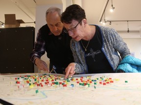 Noam and Beryl Chernick examine a map depicting where soldiers killed in the First Word War lived in London. The map was on display at the Royal Canadian Regiment Museum on Wednesday as part of the Topography of Grief. Mapping Great War dead in London exhibit. (DALE CARRUTHERS, The London Free Press)