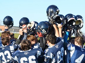 Quinte Saints players raise their helmets in a final salute following their 29-22 double O.T. loss to Peterborough TAS in the COSSA AAA junior championship football game Wednesday at Paul Paddon Field. (Submitted photo)