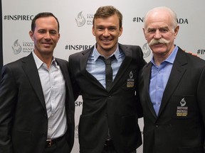 Golfer Mike Weir, from far left, former Olympic triathlete Simon Whitfield of Kingston and former NHL player Lanny McDonald pose for a photo after a news conference to announce their induction into the Canadian Sports Hall of Fame in Toronto on Thursday. (Chris Young/The Canadian Press)