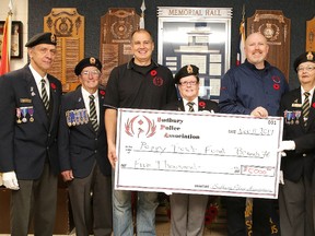 The Sudbury Police Association made a $5,000 donation Thursday to the Poppy Trust Fund to replenish funds lost due to the stolen poppy boxes put up by the Royal Canadian Legion Branch 76 in Sudbury, Ont. The donation was made by association president Randy Buchowski and treasurer Darryl Grisdale to legion member Raymond Bouchard, interim 2nd vice Bob McLay, 1st vice and poppy chair Judy Robitaille, youth education chair Gaetane McNab and president Bruce McNab. All funds in the poppy trust fund stay locally and benefit veterans and the community. The Legion is one of Canada's largest service organizations and receives no government funding. Gino Donato/Sudbury Star/Postmedia Network