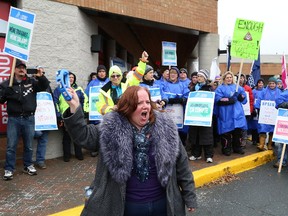 Kim McNab, of OPSEU Local 665, leads a chant at a rally for striking faculty at Cambrian College and College Boreal outside Minister of Energy and Sudbury MPP Glenn Thibeault's office in Sudbury, Ont. on Thursday November 9, 2017. John Lappa/Sudbury Star/Postmedia Network