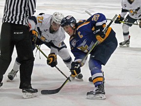 Oil Barons captain Shane Fraser (right) wins a faceoff against Garan Magnes (left) of the Saints. - Photo by Jesse Cole