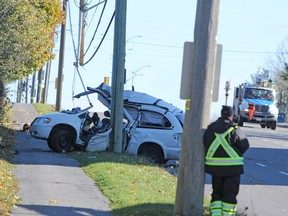 Kingston Police collision reconstructionist Const. Rick Hough investigating a single vehicle collision on King Street West on Friday, Nov. 10, 2017. Steph Crosier, Kingston Whig-Standard, Postmedia Network.