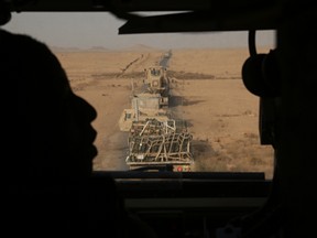 In this Monday, Nov. 6, 2017 photo, U.S. Marines transport equipment and ammunition in Anbar, Iraq. The US-led coalition's newest outpost in the fight against the Islamic State group is in this dusty corner of western Iraq near the border with Syria where several hundred American Marines operate close to the battlefront, a key factor in the recent series of swift victories against the extremists. (AP Photo/Khalid Mohammed)