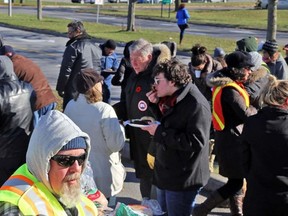 TIM MEEKS/THE INTELLIGENCER
Former Prince Edward-Hastings MP Daryl Kramp (centre) discusses the ongoing Ontario college teachers strike with a faculty member during an OPSEU lunch rally Friday at Loyalist College. OPSEU has advised faculty at Ontario's 24 colleges to vote no to the College Employers' Council final contract offer delivered this week when a online vote takes place Nov. 14-16.