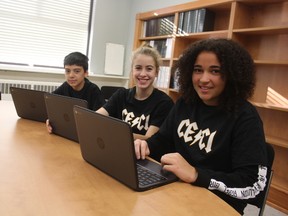 Grade 9s Dylan Figueiredo, left, Faith DeVries and Kiki Wilson work on their new laptops, which were given to them on Wednesday by the Thames Valley district school board as part of a pilot project. Every Grade 9 student in eight schools across the school board were provided with a Chromebook. (Laura Broadley/Times-Journal)