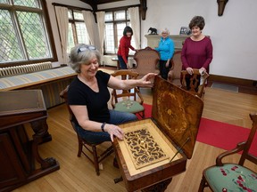 Susan Bentley, of the Heritage London Foundation, admires a sewing desk belonging to Elsie Perrin Williams at the Elsie Perrin Williams Estate. With her are other Marlyn Loft, left, Louanne Henderson and Maggie Whaley, also members of the foundation that oversees operation of the home. (MORRIS LAMONT, The London Free Press)
