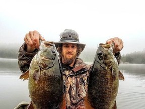 Columnist Frank Clark’s son, Frank Jr., hoists up one of many double headers of giant fall bass from a recent outing on a small lake. Photo supplied