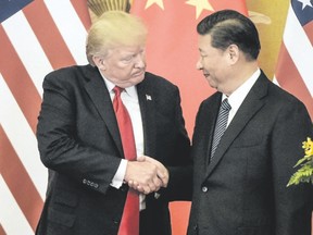 U.S. President Donald Trump presses palms with China?s President Xi Jinping at the end of a press conference in Beijing on Thursday. (FRED DUFOUR/AFP/Getty Images)