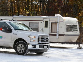 Park officials drive by a trailer left by Indigenous protesters near the entrance to Pinery Provincial Park outside Grand Bend. The protesters, calling themselves the descendants of Chippewa Grand Chief Wabgance, argue land that includes the park is rightfully theirs. (The Canadian Press)