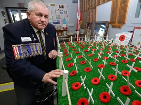 Brian Harris, Southwest Ontario Legion Commander looks over the rows of crosses in the lobby of the Victory Legion in London, representing members who died in action. (MORRIS LAMONT, The London Free Press)