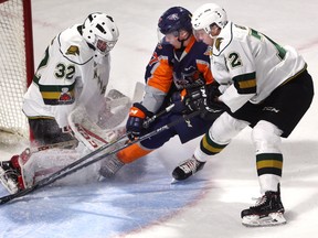 Knights goalie Joseph Raaymakers holds his ground as Jack Wismer of the Flint Firebirds drives the crease while being guarded by London defenceman Alec Regula during the first period of their OHL game at Budweiser Gardens on Friday night. Raaymakers made 32 saves for the shutout in a 9-0 rout. (MIKE HENSEN, The London Free Press)
