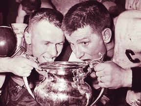 Player-coach Ike Hildebrand (left) and team captain Floyd Crawford drink from the Allan Cup in 1958 in Kelowna, BC, where the locals rallied from a 3-1 best-of-seven series deficit to capture the Canadian Sr. A hockey title. (Belleville Sports Hall of Fame)