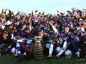 The Western Mustangs pose for a team photo with the Yates Cup after they destroyed the Laurier Golden Hawks 75-32 to avenge last year's loss on Saturday November 11, 2017. 
Mike Hensen/The London Free Press/Postmedia Network