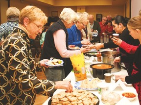 People dish up on various foods from around the world at the Smorgasbord video showing at the Vulcan Lodge Hall Thursday evening, Nov. 9.