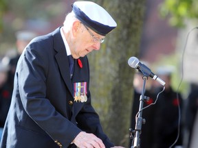 Second World War Navy veteran Bill Fitsell reads the Act of Remembrance during a Remembrance Day ceremony at Navy Memorial Park on Saturday. (Steph Crosier/The Whig-Standard)