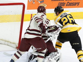 The Petes' Gleb Babintsev and goalie Dylan Wells and the Kingston Frontenacs' Ted Nichol watch the puck cross the goal-line during first-period OHL action in Peterborough on Sunday. The goal was disallowed because the net came off its mooring before the puck went in. (Clifford Skarstedt/The Whig-Standard)