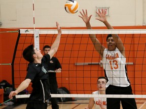 Miguel Mrochek, left, of Horizon Aigles, attempts to tip the ball past Nathan Scully, of Lasalle Lancers, during senior boys volleyball final action at Lasalle Secondary School in Sudbury, Ont. on Saturday November 11, 2017. John Lappa/Sudbury Star/Postmedia Network