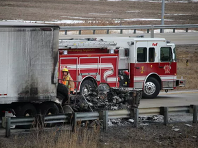 Fire and police officials on the scene of a fatal transport fire on westbound Highway 402, south of Sarnia, on Jan. 31, 2016. (BARBARA SIMPSON, Sarnia Observer)