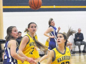 Myah Vingerhoeds (25) of the Mitchell Blue Devils, Joanna Vandewalle and Kathryn Simmons (32) of the hometown St. Mike's Warriors keep their eyes on the basketball that appears to be floating during Huron-Perth senior girls basketball semi-final action Wednesday, Nov. 8. Simmons, a Mitchell resident, was the game's high scorer with 13 points to lead the Warriors to a 48-14 victory and a berth in the H-P final which they won as well, defeating Stratford Northwestern. ANDY BADER/MITCHELL ADVOCATE