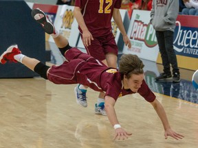 A diving Gabe Plata of the Regiopolis-Notre Dame Panthers has the ball fall just out of his reach during the Kingston Area Secondary Schools Athletic Association senior boys volleyball final Sunday afternoon at the Queen's Athletics and Recreation Centre. The Panthers won their 13th KASSAA title in a row, edging the Golden Eagles 3-2 (25-19, 25-11, 18-25, 15-25, 15-12). (Tim Gordanier/The Whig-Standard)