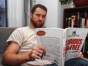 Alex Huntley, editor and senior writer with The Beaverton, relaxed with a good book at home in Kingston, Ont. on Thursday November 9, 2017. Julia McKay/The Whig-Standard/Postmedia Network