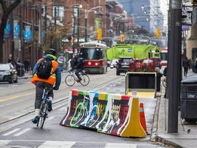 A complex new project aimed at tackling transit woes along a bustling street in Canada’s most populous city got its first real test with commuters Monday, drawing mixed reactions from motorists and transit users.