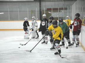 Campers practice rushing with pucks during November Hockey Camp on Nov. 9 (Peter Shokeir | Whitecourt Star).