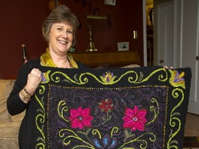 Joanne Hipwell shows the hooked rug pattern purchased by her son-in-law?s grandmother, which she finished and gave to the couple as a present. (Mike Hensen/The London Free Press)