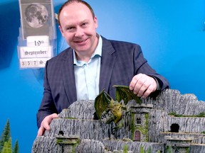 Western University professor Robert Wardhaugh adds a fire-breathing foe to his custom-made Dungeons & Dragons tabletop. Wardhaugh has been master of the same D&D campaign for 35 years — perhaps the longest continuous quest in the world. (CHRIS MONTANINI\LONDONER\POSTMEDIA NETWORK)