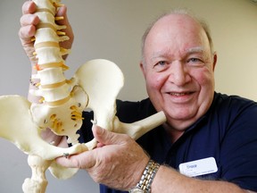 Luke Hendry/The Intelligencer 
Chiropractor Dr. Bruce Flynn holds a model of the lower back and pelvis Tuesday at the Belleville Nurse Practitioner-Led Clinic. He and clinic staff are part of a provincially-funded project to reduce lower back pain and patients' use of painkillers. It won an award recently from the Association of Family Health Teams of Ontario.