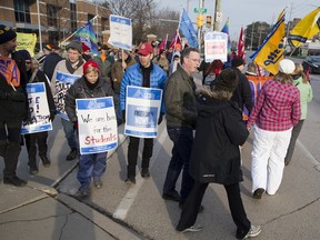 Striking faculty and supporters picket Tuesday outside Fanshawe College. Weary of the weeks-long strike pickets non-the-less seem determined to get that for which they walked of the job. (Derek Ruttan/The London Free Press)