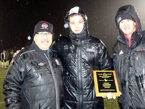 Garrett Edwards, middle, a teacher from Sudbury who is studying at Keyano College in Fort McMurray, Alta., shows off his Exemplary Leadership Award at the CCAA national men's soccer championship in Nanaimo, B.C. on Saturday. CCAA Photo