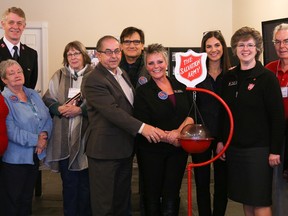 Tim Miller/The Intelligencer
Members of the Salvation Army and others kick off the 2017 Christmas Kettle Campaign at the Business Downtown Improvement Area (BDIA) offices on Wednesday November 15, 2017 in Belleville, Ont. Pictured from left: Marlene Goodfellow; Shirley Dewey; Maj. Wil Brown-Ratcliffe, Salvation Army; Brenda Ryan; Coun. Garnet Thompson; Michael Malachowski; Debbie Scott, campaign co-ordinator; Monica Rodrigues of Kafka, Kort Barristers; Abby Mills, director of community and family services of the Belleville Salvation Army; Joe Drummond; and Hazel Lloyst, BDIA office manager.