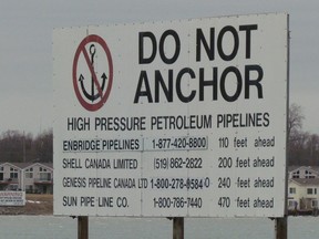 A sign  near Corunna, south of Sarnia, Ont., marks where several pipelines cross the St. Clair River between Michigan to Ontario. Environmentalists in Michigan want a section of an Enbridge pipeline crossing the Straits of Mackinac to be shut down. The pipeline carries oil and gas to Sarnia. (File photo/Sarnia Observer/Postmedia Network)