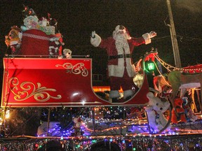 Santa Claus wishes the crowds Merry Christmas while he waves from his sleigh during the 2014 Kingston Nighttime Santa Claus parade route on Saturday November 22, 2014. Julia McKay/Kingston Whig-Standard